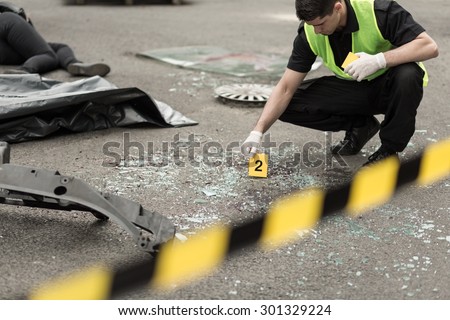 Policeman during investigation at road accident area