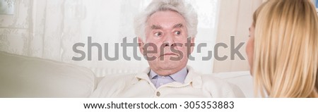 Old man is listening to his private nurse