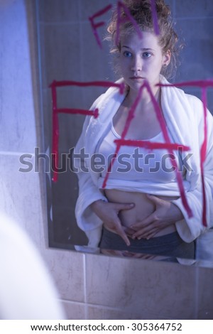Image of frustrated anorexic girl with desire of thin body