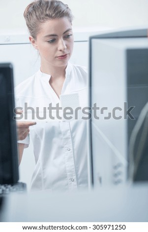 Woman in white coat working in laboratory