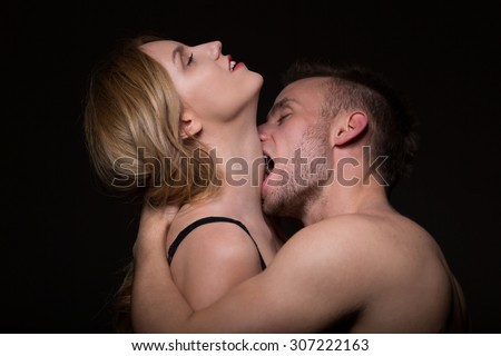 Man passionately kissing and biting a woman in the neck