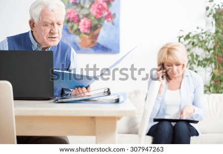 Elder businesspeople checking important docuemnts of their company
