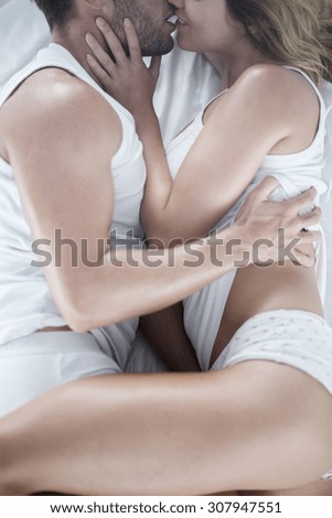 Close up of passionate beautiful couple together in bed