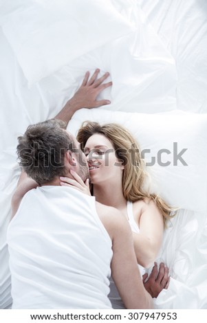 Image of pair in love flirting in white bedroom
