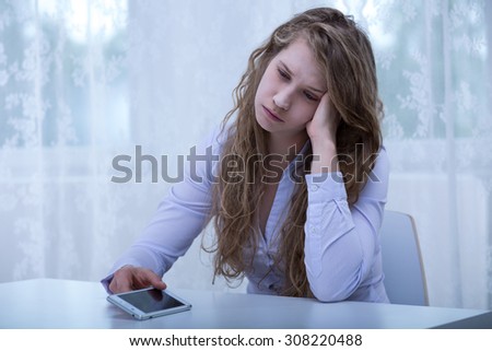 Photo of scared girl receiving messages with threats