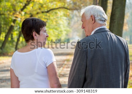 Elderly man and woman dating in park