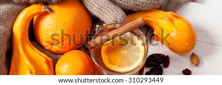 Winter fruits and drink, hot tea and oranges