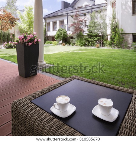 Picture of a house patio with stylish rattan table