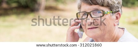 Elder woman talking on the phone - panorama