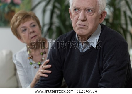 Lady is apologisong her sad and angry husband