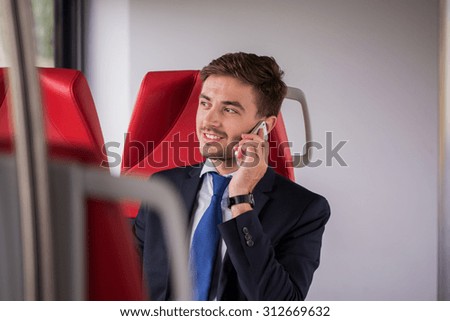 Photo of eco living businessman using train instead of car