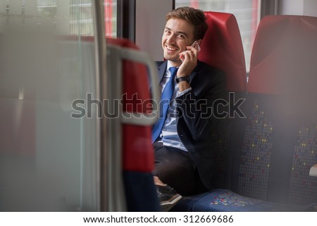 Photo of corporate worker with cellphone on business trip