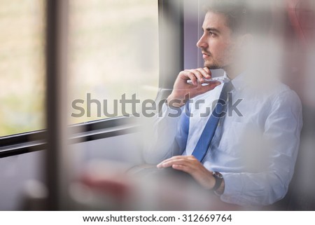 Picture of handsome businessman using commuter rail