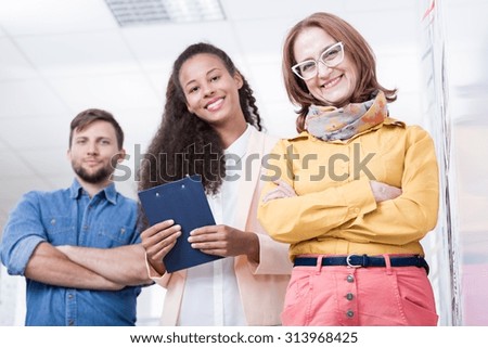 Photo of female company director and two young interns