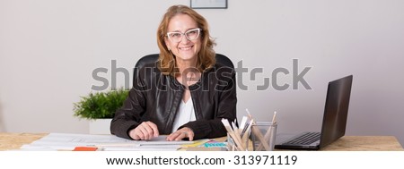 Panorama of self-employed experienced professional businesswoman during work