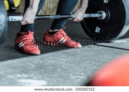 Man practicing weight lifting in the exercise room