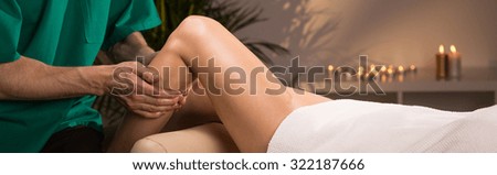 Beauty woman relaxing during pleasant leg massage