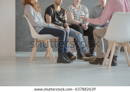 several people sitting in a semi-circle and talking