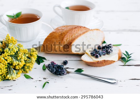 Diet breakfast with Herbal tea and  bread with butter and blueberries