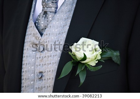 groom suit with white rose