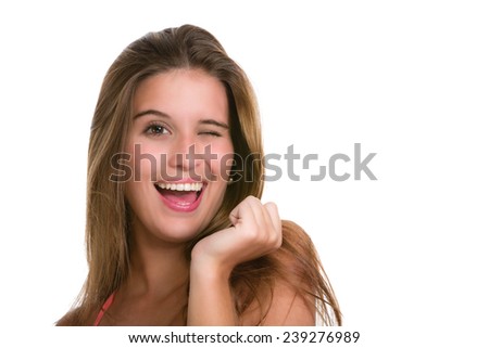 Close up of Hispanic young woman winking eye.  Image isolated on white with clipping path.