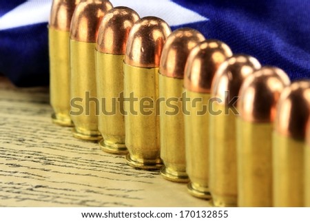 Row of 45 caliber ammunition with US flag in background