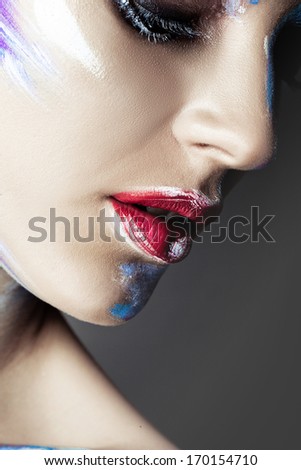 Close-up shot of woman lips with glossy fuchsia lipstick