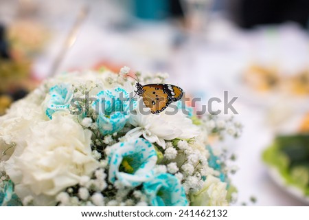 Butterfly sitting on a wedding bouquet