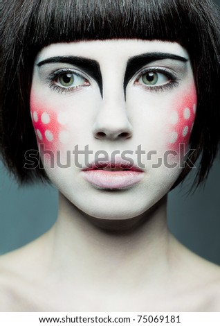 woman with creative makeup with circles on the cheeks