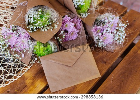 Envelope and flower bouquet on the wooden table