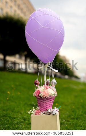 Bouquet of carnation flowers and sweets on a balloon