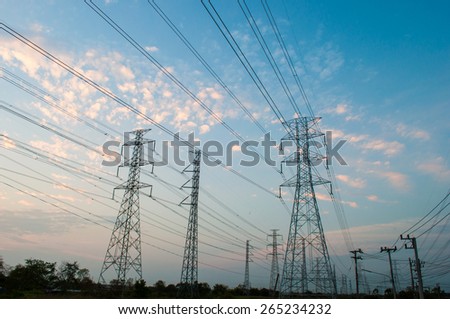 High voltage electricity pylon against the background sky of sunset light colors.