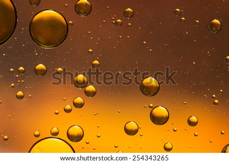 Oil and water abstract in gold, giving the impression of rising bubbles