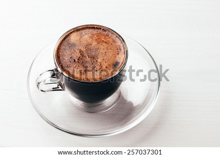 Overhead view of coffee with foam, close up, macro, in glass cup, Coffee background, Coffee foam texture