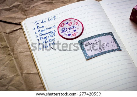 Notebook page with to do list and stickers. With shallow depth of field.
