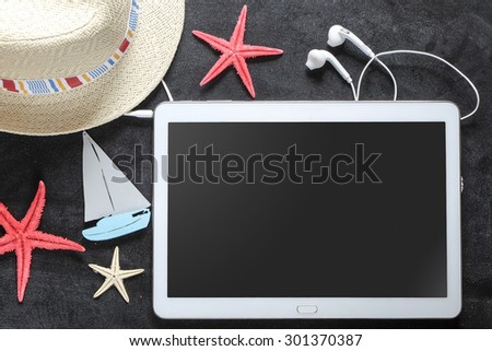 Summer objects for vacation organized around tablet PC