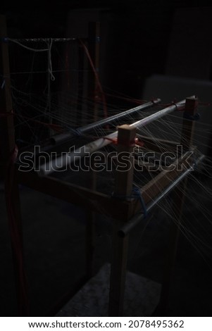 Non-machine looms (ATBM) are tools for weaving that are driven by humans. ATBM can be used while sitting (usually in small and traditional textile industries) or standing. Photo stock © 