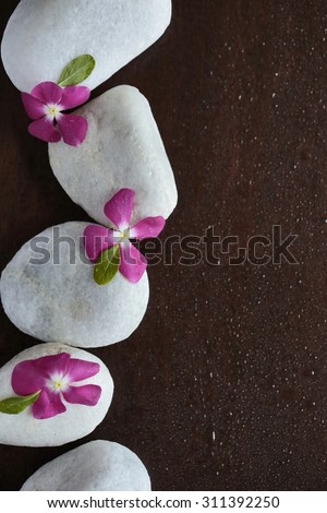 a candle in the background, white stones with purple, flowers, spa, salon, wet, beautiful, pink, natural, fresh, clean, easy, pleasant, warm, fire, wood background, water, drops, flowers
