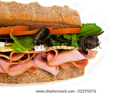 A gourmet sandwich of ham, cheese, lettuce, tomato and mayonnaise isolated on white.