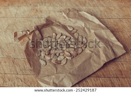 pumpkin seeds on grey paper