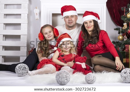 a family man, a woman and two girls in Christmas cover and interior