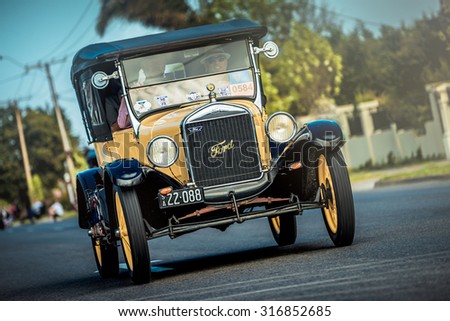 Adelaide, South Australia - September 28, 2014: Old Ford T car with people on board is driving on the street during the Bay to Birdwood car run.