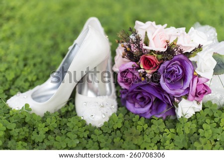 purple wedding flowers and bridal shoes