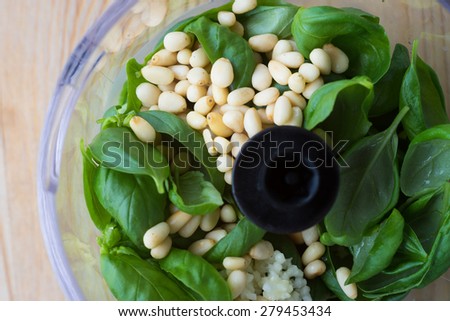 Ingredients for Pesto Sauce in a Plastic Bowl of Food Processor