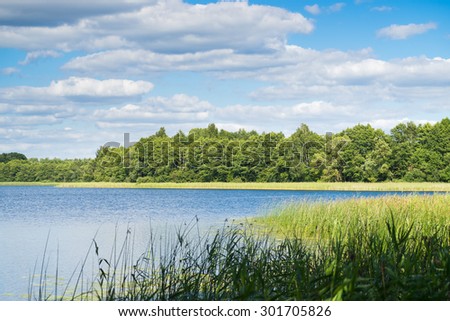 Landscape with a Lake, Trees and Clouds on a Sunny Day, Belarus