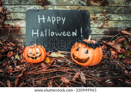 Happy Halloween. Holiday pumpkins and decorations. Pumpkin on autumn street. Preparations for the holiday decoration bats and manufacturing Hallowe\'en pumpkin