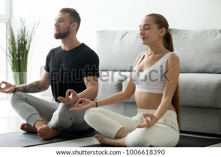 Similar – Image, Stock Photo Focused couple doing yoga in Awkward pose in park