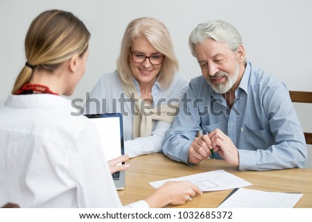 Real estate agent showing house plan to aged couple, realtor making property for sale offer to senior customers at meeting, financial advisor consulting older family negotiating about buying new home Photo stock © 