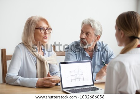 Senior couple talk to real estate agent about house purchase at meeting, interior designer advisor consulting older family with home plan on laptop screen, aged man and woman negotiating with realtor Photo stock © 
