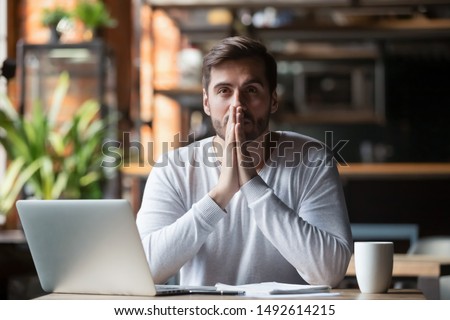 Thoughtful doubtful businessman in tension thinking make difficult decision at work, stressed man put hands in prayer pray with hope pondering reflecting concerned about problem challenge sit at desk 商業照片 © 